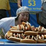 Takeru Kobayashi of Japan, posed with 53 1/2 hot dogs after winning the Nathan's Famous Fourth of July International Hot Dog Eating contest in 2004.